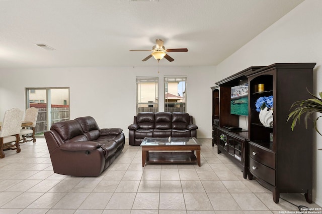 tiled living room featuring plenty of natural light and ceiling fan