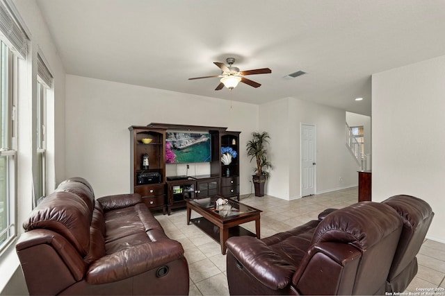 living room featuring light tile patterned floors and ceiling fan