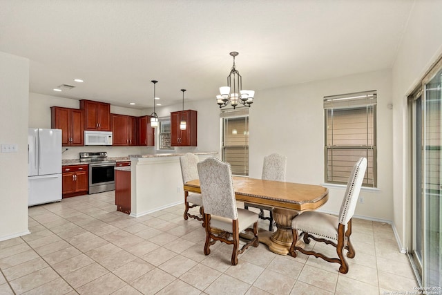 dining area with an inviting chandelier and light tile patterned floors