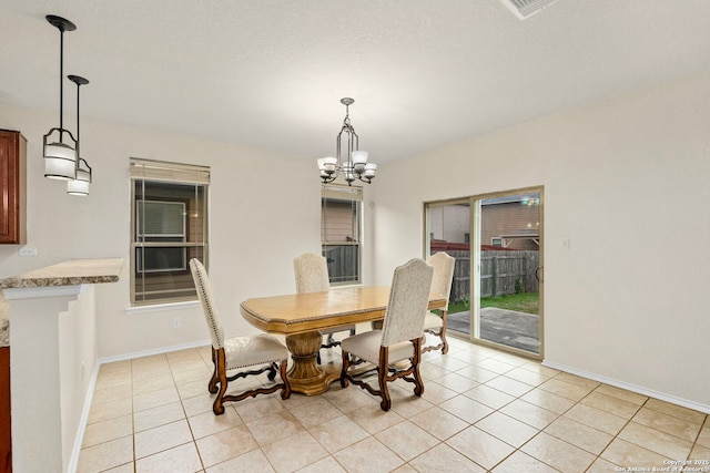 dining area featuring light tile patterned floors and a chandelier