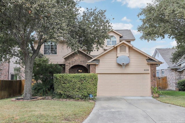 traditional home with a garage, concrete driveway, brick siding, and fence