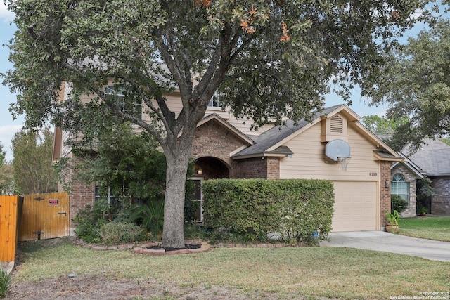 view of front of house featuring brick siding, concrete driveway, an attached garage, fence, and a front yard