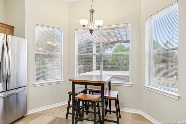 dining space featuring plenty of natural light and a notable chandelier