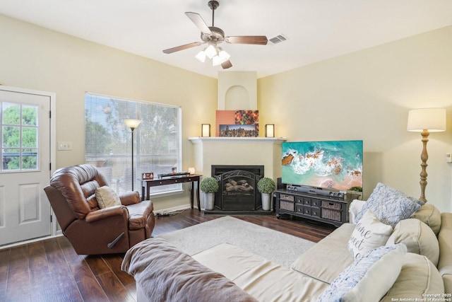 living room with dark wood-type flooring and ceiling fan