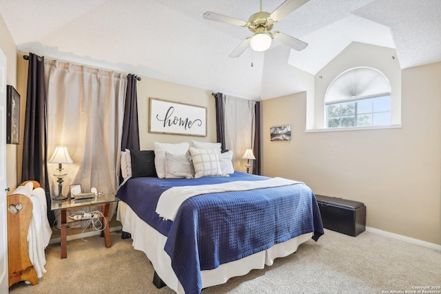 carpeted bedroom with lofted ceiling, a textured ceiling, and ceiling fan