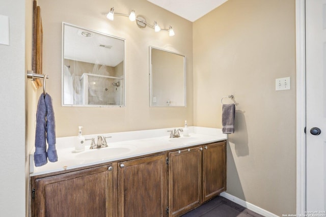 bathroom featuring vanity and a shower with door