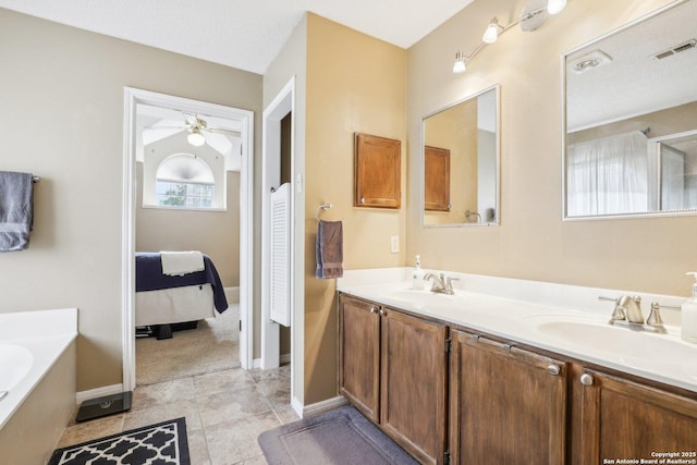 bathroom with ceiling fan, vanity, and a bathing tub