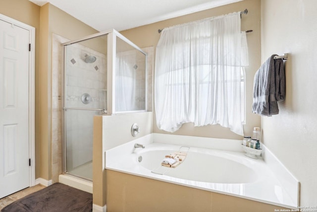 bathroom featuring separate shower and tub