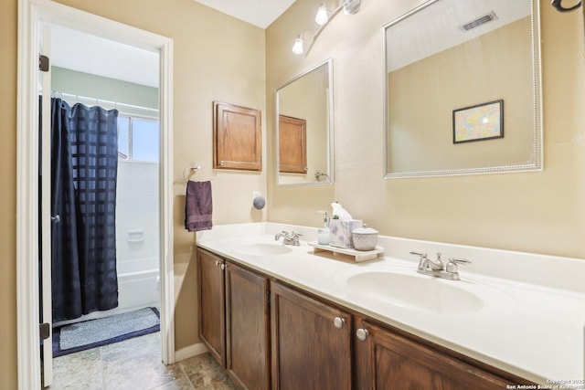 bathroom with shower / bathtub combination with curtain and vanity