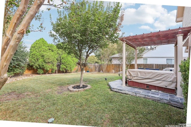 view of yard featuring a covered hot tub and a pergola