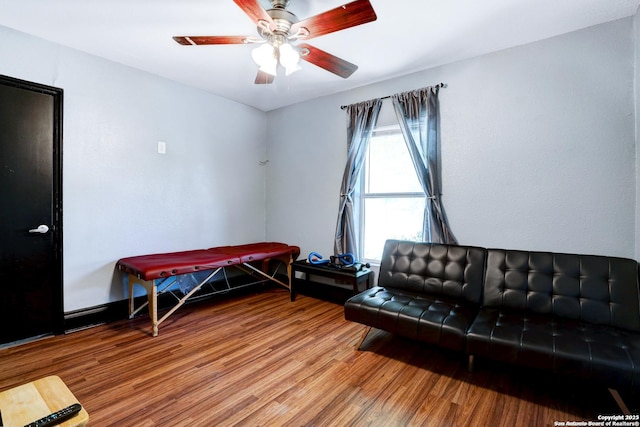 living area with hardwood / wood-style flooring and ceiling fan