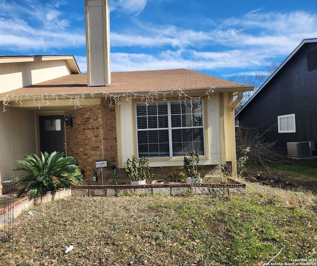 rear view of house with central AC unit