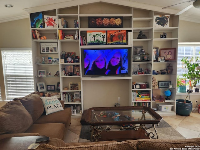 living room with tile patterned flooring, ornamental molding, and lofted ceiling