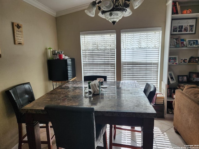 dining area featuring light tile patterned flooring and crown molding