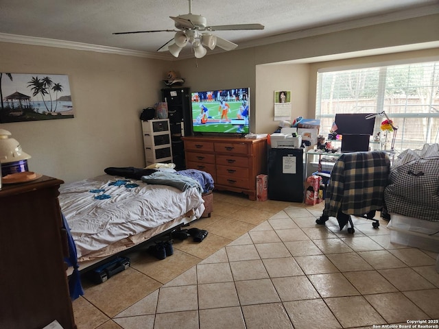 tiled bedroom featuring crown molding, a textured ceiling, and ceiling fan