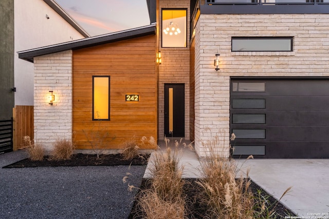 exterior entry at dusk with a garage