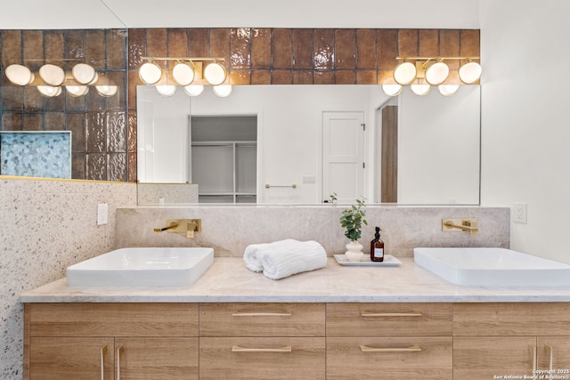 bathroom featuring vanity and decorative backsplash