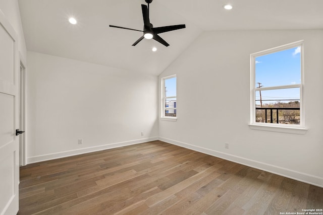 spare room featuring ceiling fan, wood-type flooring, and vaulted ceiling