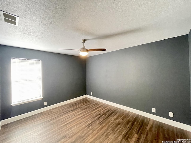 spare room with ceiling fan, wood-type flooring, and a textured ceiling