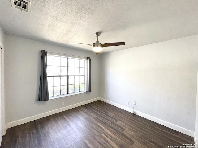 empty room featuring ceiling fan, dark hardwood / wood-style floors, and a textured ceiling