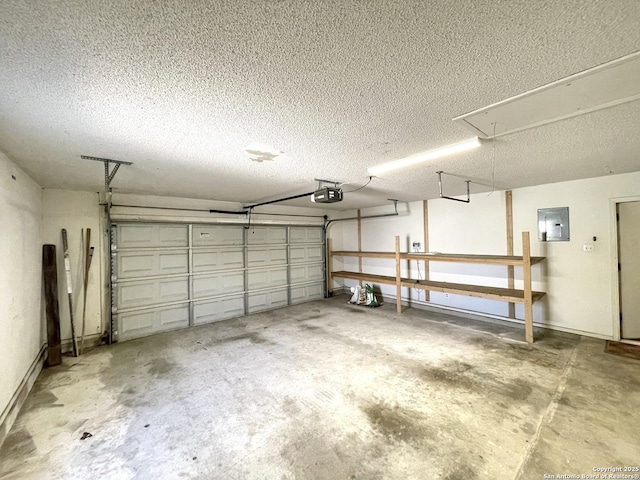 garage with a garage door opener and electric panel