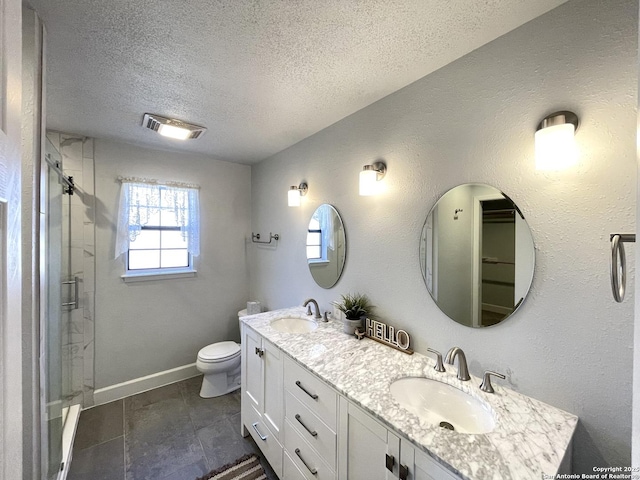 bathroom with vanity, an enclosed shower, a textured ceiling, and toilet