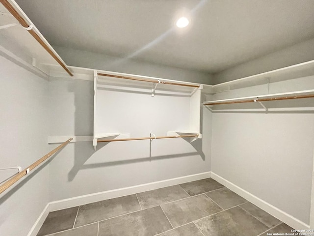 spacious closet with tile patterned floors