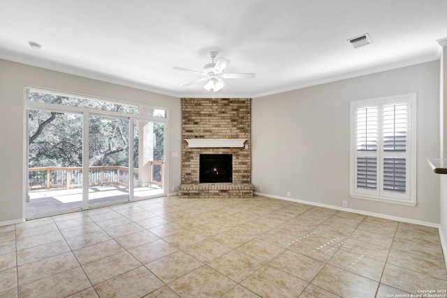 unfurnished living room with light tile patterned flooring, ceiling fan, ornamental molding, and a brick fireplace