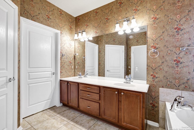 bathroom with a tub to relax in, tile patterned floors, and vanity