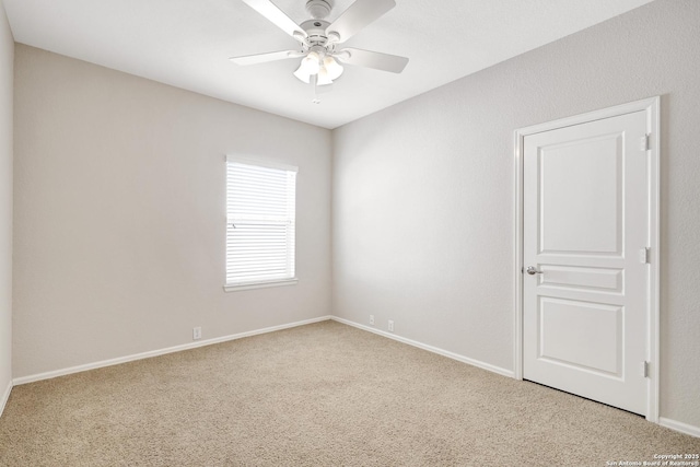 carpeted empty room featuring ceiling fan