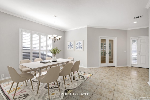 tiled dining room featuring crown molding, a chandelier, and french doors