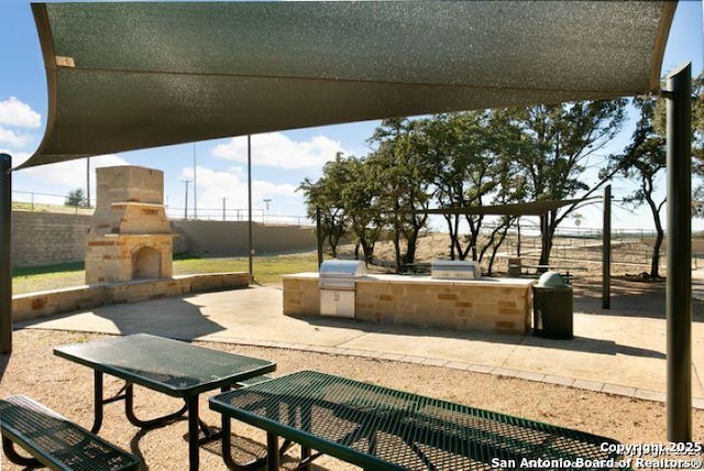 view of property's community with an outdoor kitchen and a patio