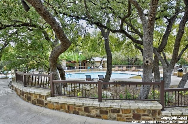 view of home's community with a pool