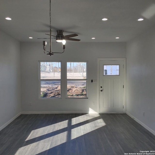 foyer featuring dark wood-type flooring and a chandelier