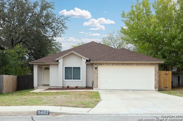 single story home featuring a garage and a front yard