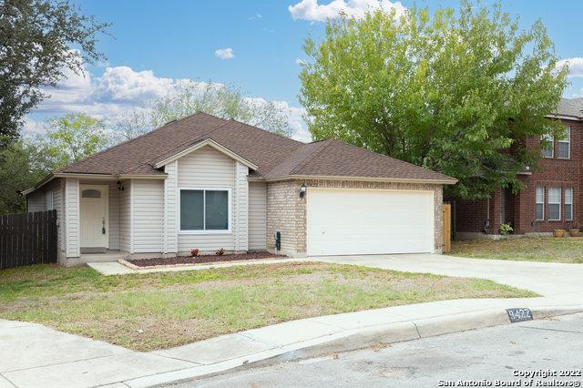 view of front of home with a garage and a front lawn