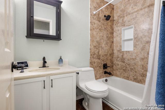 full bathroom featuring vanity, toilet, and shower / tub combo