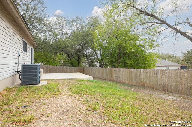 view of yard featuring central AC and a patio