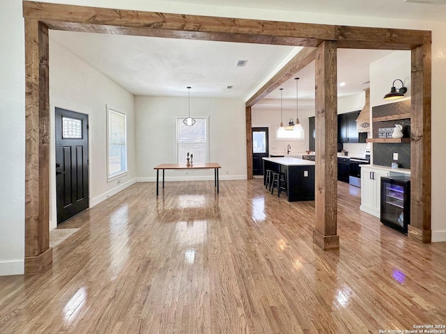 interior space featuring wine cooler and hardwood / wood-style flooring