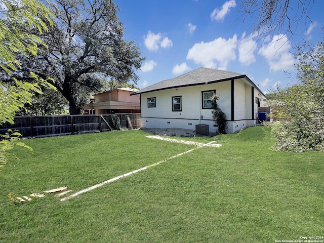 rear view of house featuring a lawn