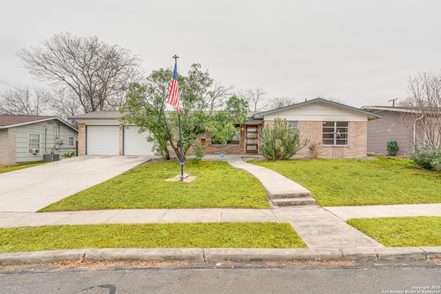 single story home with a garage, a front yard, and cooling unit