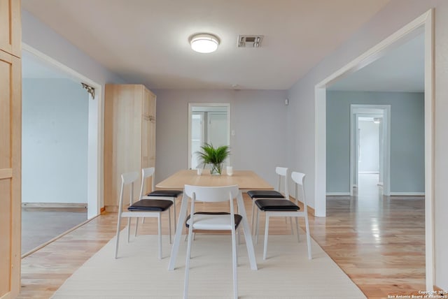 dining area featuring light wood-type flooring