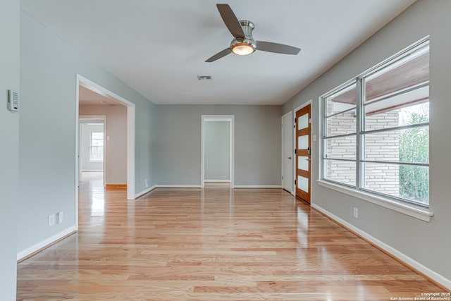 empty room featuring ceiling fan and light hardwood / wood-style floors