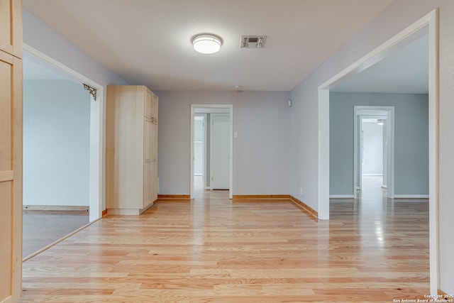 empty room with light hardwood / wood-style floors