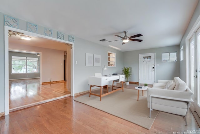 living room with ceiling fan and hardwood / wood-style floors