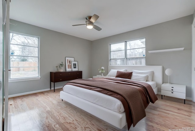 bedroom with ceiling fan and light wood-type flooring