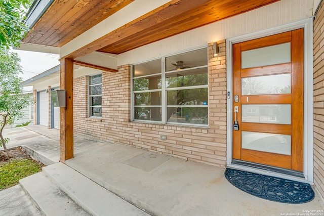 entrance to property featuring a porch and a garage