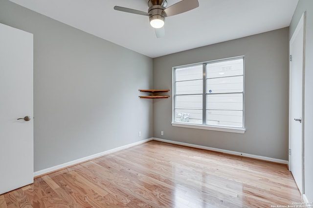 empty room featuring ceiling fan and light wood-type flooring