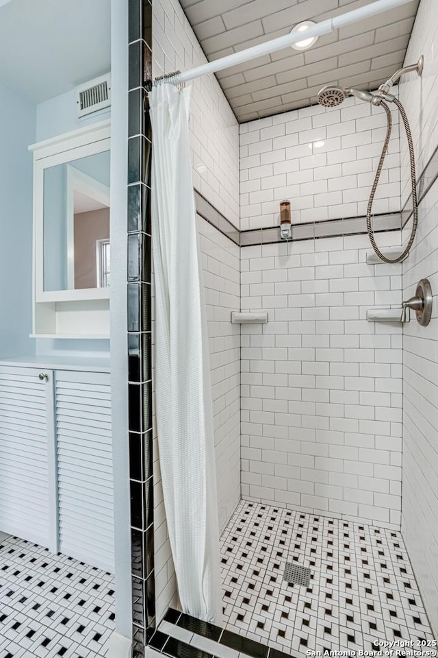 bathroom featuring tile patterned flooring and a shower with curtain