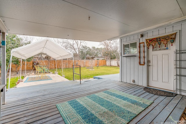 wooden terrace featuring a yard